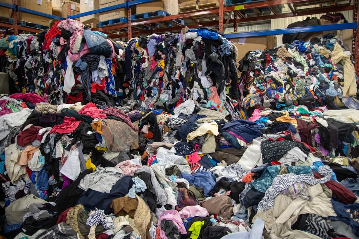 Les vêtements usagés forment des montagnes dans l'entrepôt de Renaissance.