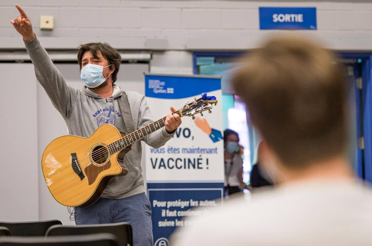 Ouverture de la vaccination sans rendez-vous contre la COVID-19 au Palais des congrès de Montréal, pendant la troisième vague de la pandémie de COVID-19, le jeudi 13 mai 2021. Sur cette photo: Le chanteur Émile Bilodeau chante au centre de vaccination. JOËL LEMAY/AGENCE QMI