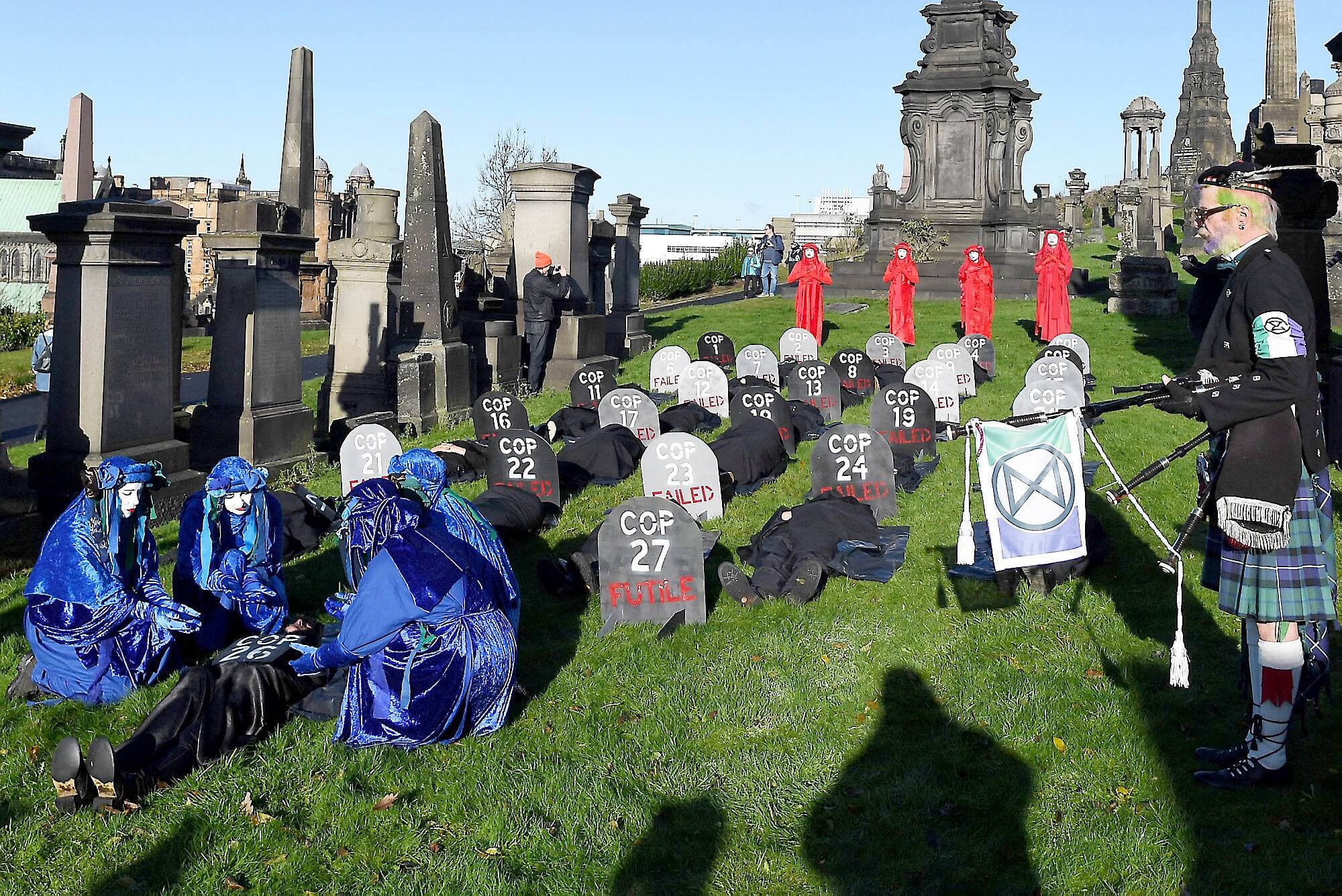 Des membres des brigades des rebelles rouges et des rebelles bleus, de l’organisation environnementale Extinction Rebellion, ont interprété une cérémonie funéraire au cimetière Necropolis, de Glasgow, en Écosse, samedi, estimant que la conférence COP26 sur les changements climatiques a été un échec.