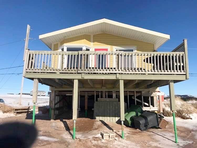 La maison de Cybèle Pelletier située sur le chemin des Chalets, aux Îles-de-la-Madeleine, se trouvait sur ces pieux et reposait sur cette base de briques avant que les eaux ne la soulèvent plusieurs mètres plus loin.