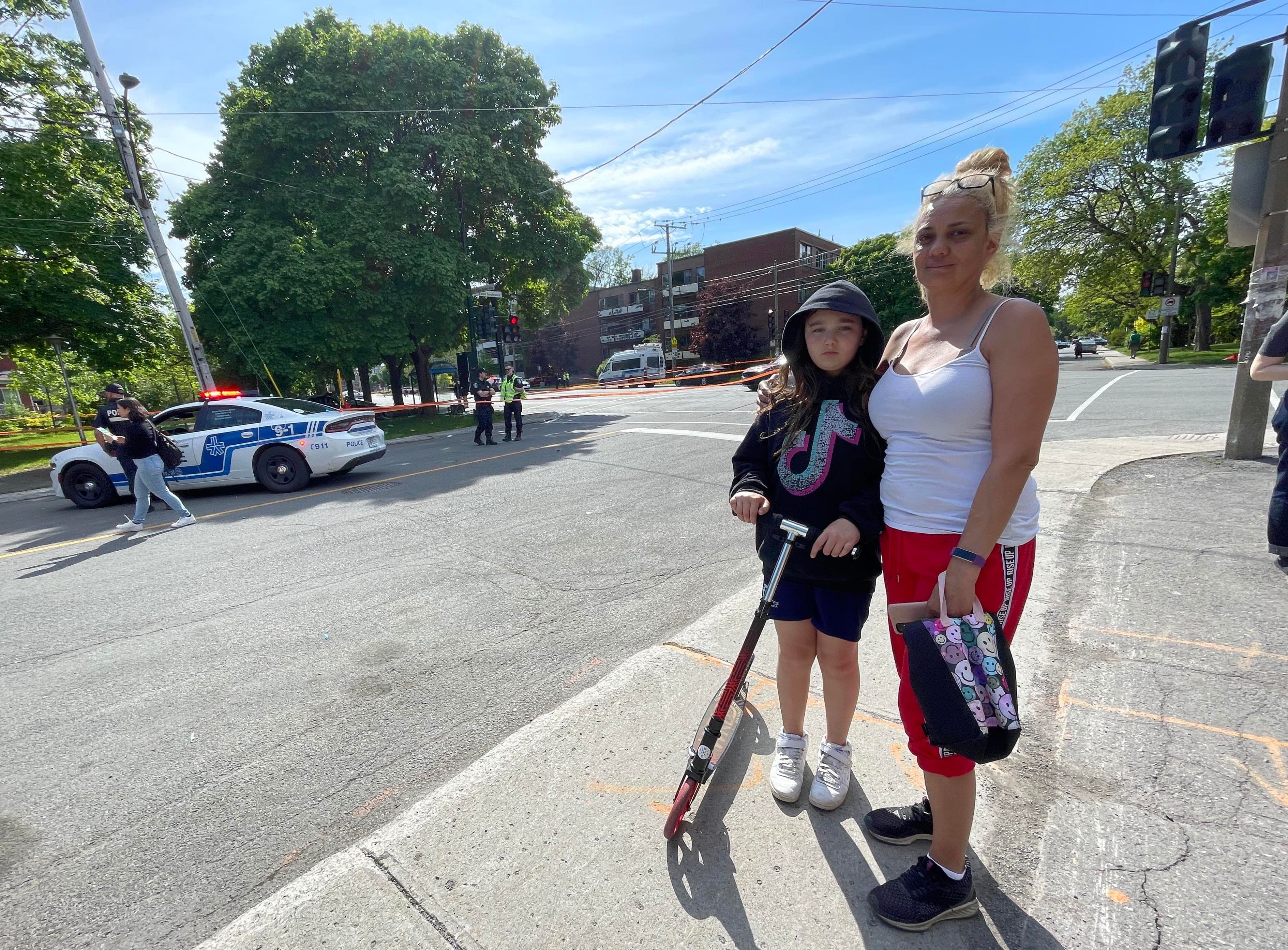 Cristina Berry, en compagnie de sa fille Mélina, devant le scène où une voiture a foncé dans un abribus vendredi après-midi à Montréal.
